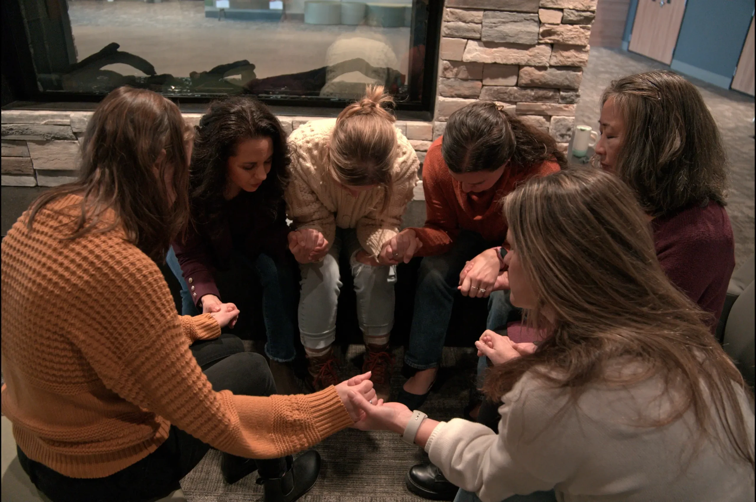 Women Praying in a Circle holding hands