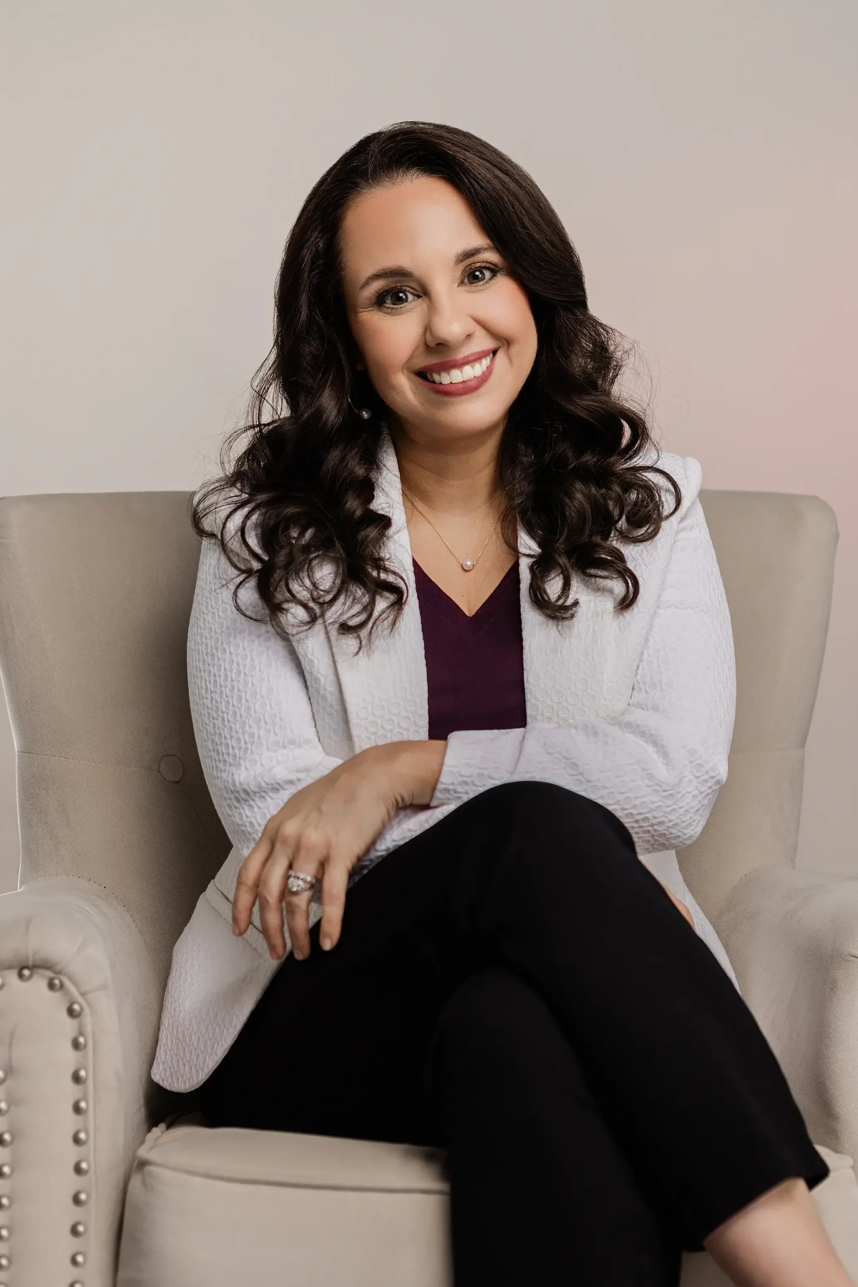 Melisa Berry sitting in a white armchair