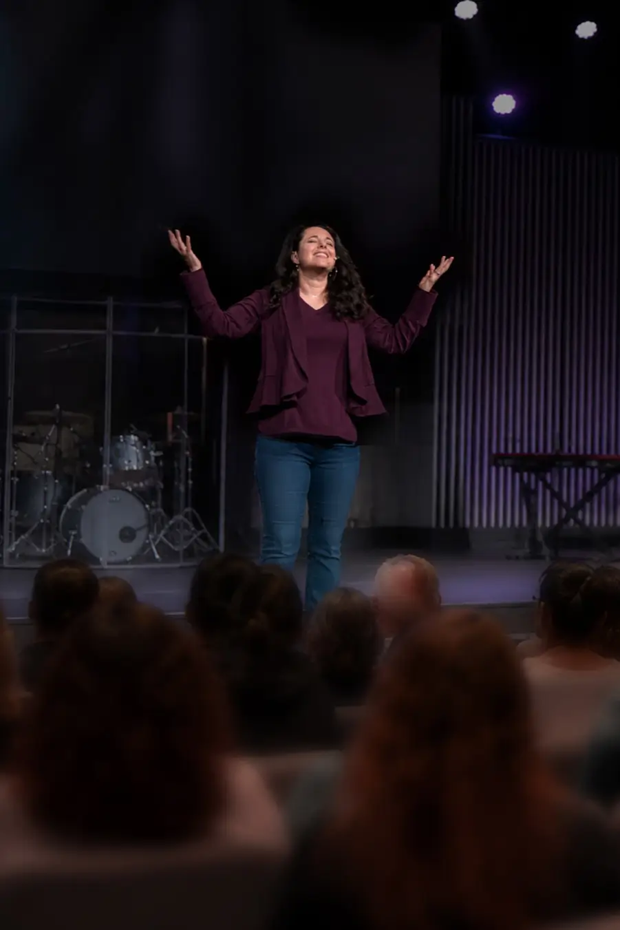 Melisa Berry speaking in front of audience